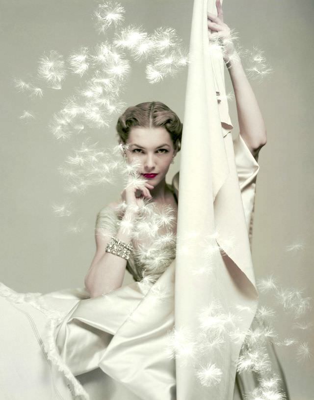 #10 Georgia Hamilton in silk taffeta dress holding yards of silk by Ducharne and C.M. Gourdon, Vogue 1949