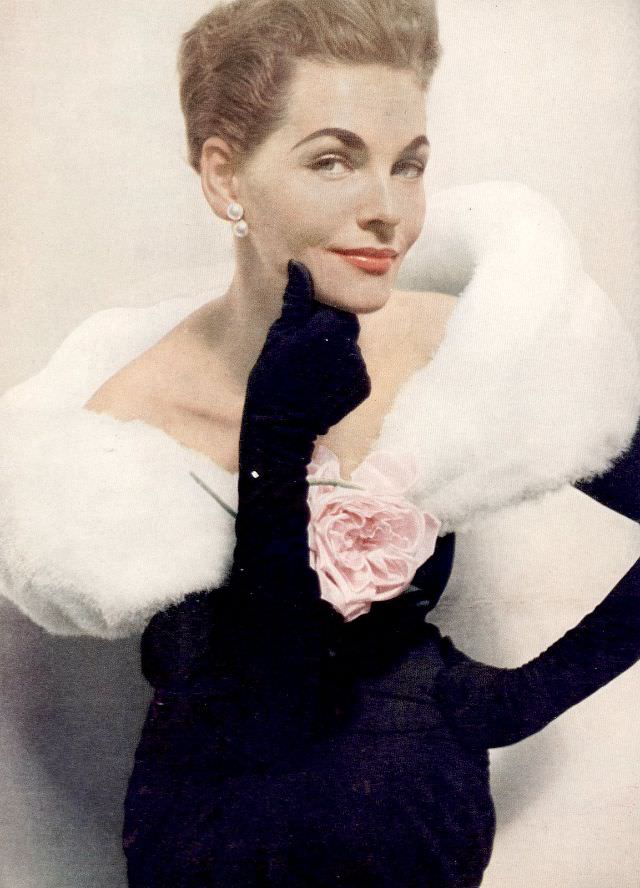#24 Georgia Hamilton is wearing black sheath with white down fichu held with pink rose by Balenciaga, Harper’s Bazaar, December 1953