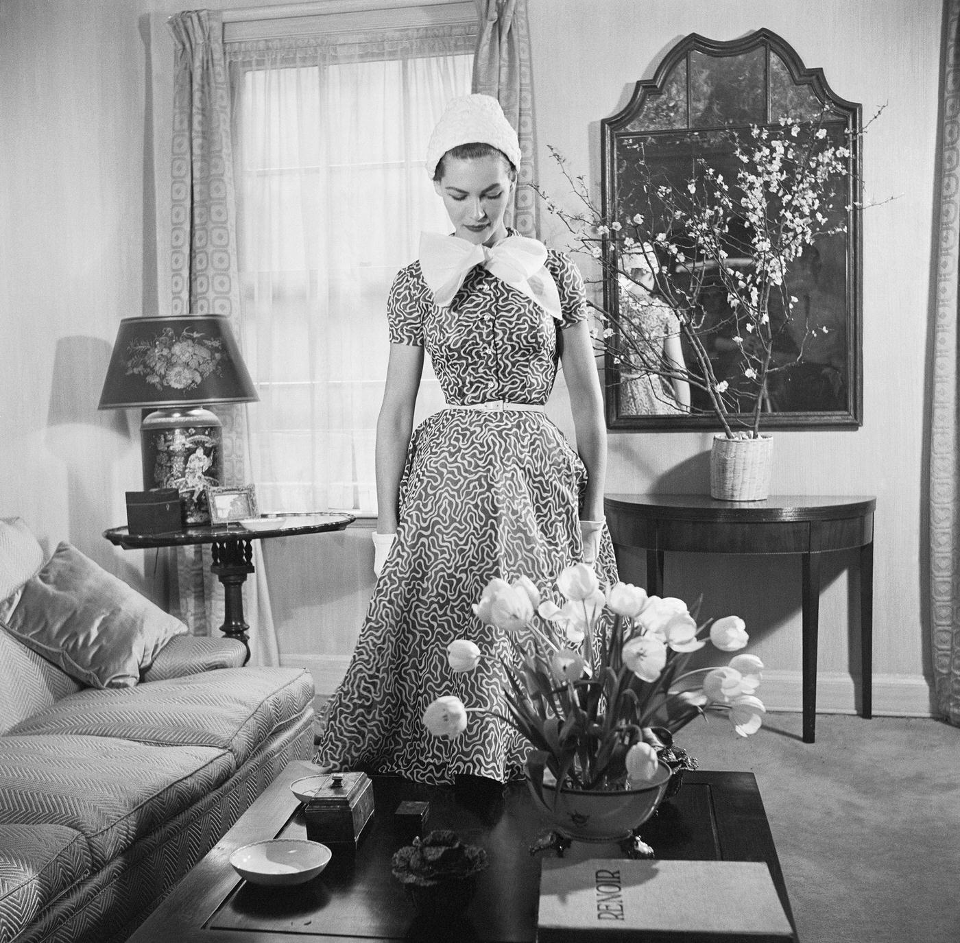 #37 Georgia Hamilton models a slate gray and white day dress by Carolyn Modes.