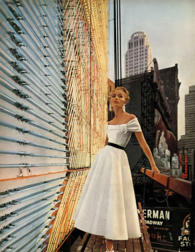 #1 Sandra Nelson in white silk organdy dress with a little shawl around the shoulders by Mollie Parnis, photo by Gleb Derujinsky, Harper’s Bazaar, December 1952