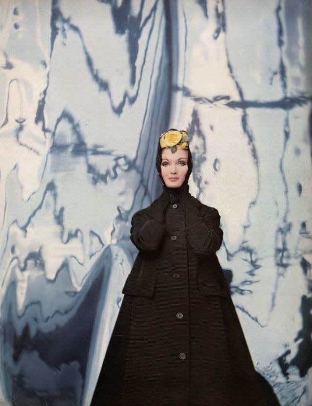 #21 Evelyn Tripp in triangular black ottoman coat with a cardigan collar by Originala, mantilla with yellow rose by Emily Wetherby, photo by Gleb Derujinsky, Harper’s Bazaar, February 1959
