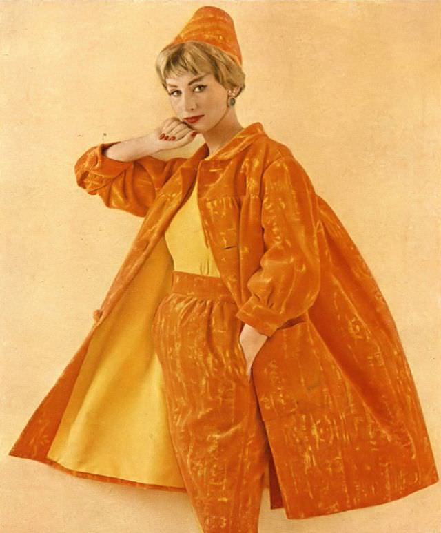 #24 Ruth Neumann Derujinsky in dinner suit of orange and yellow velveteen, matching cone hat by Emme, photo by Gleb Derujinsky, Harper’s Bazaar, April 1959
