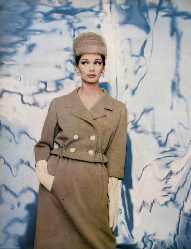 #29 Simone d’Aillencourt in nut-beige wool jersey suit, the short jacket has elasticized waist above slender gathered skirt by Ben Zuckerman, hat by Lilly Daché, photo by Gleb Derujinsky, Harper’s Bazaar, February 1959