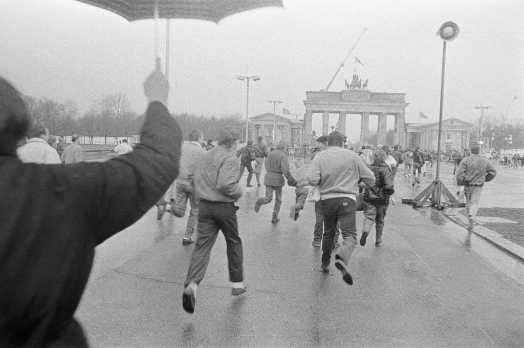 #9 After the opening of the Wall on December 22nd, 1989, people walk towards the Brandenburg Gate, 1989