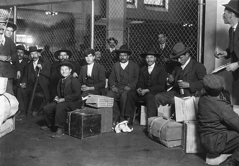 #5 Group of Italians in the Railroad Waiting Room, Ellis Island, 1905.