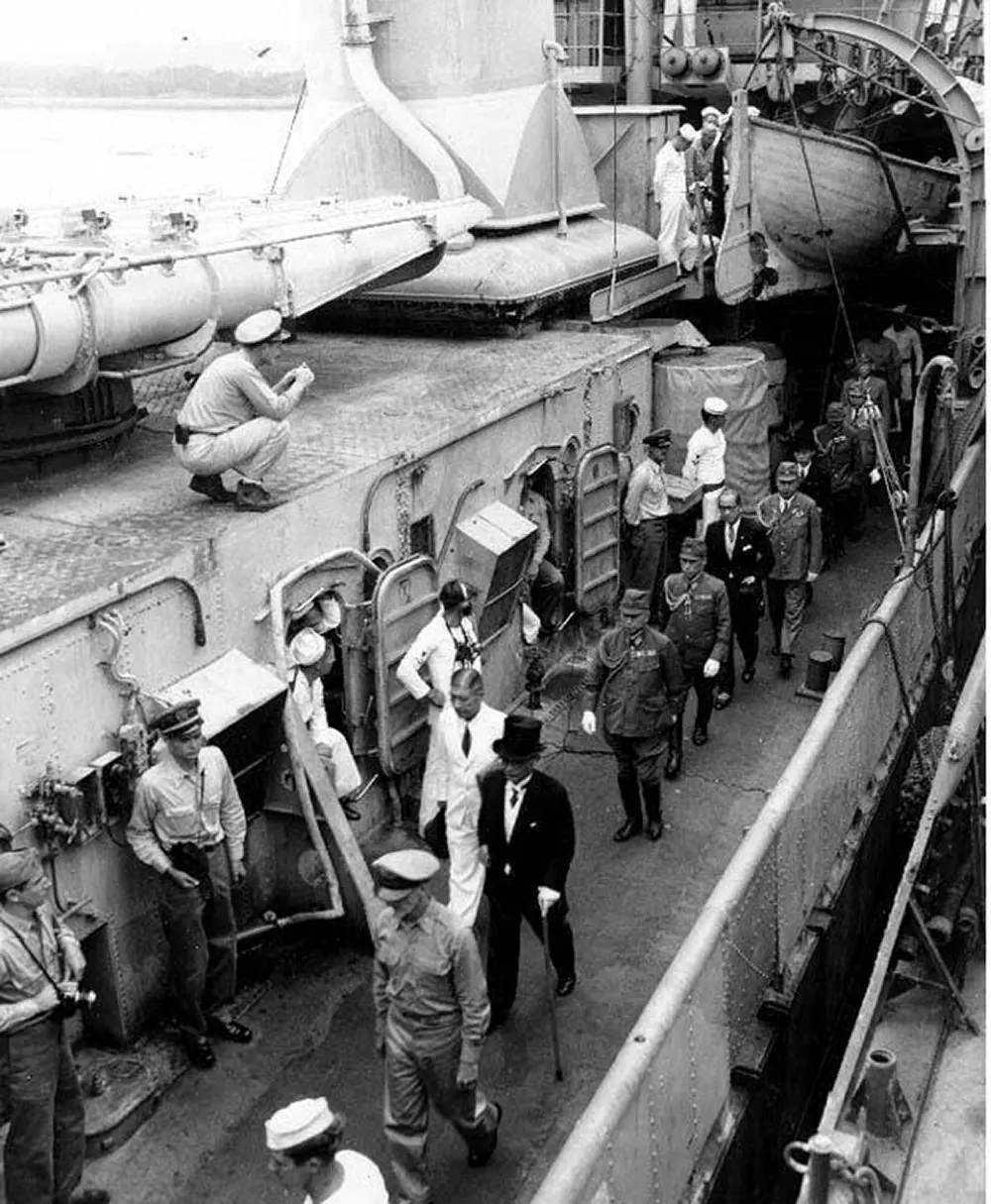 #14 Japanese representatives follow their escort officer along the deck of USS Lansdowne (DD-486), after the surrender ceremonies.