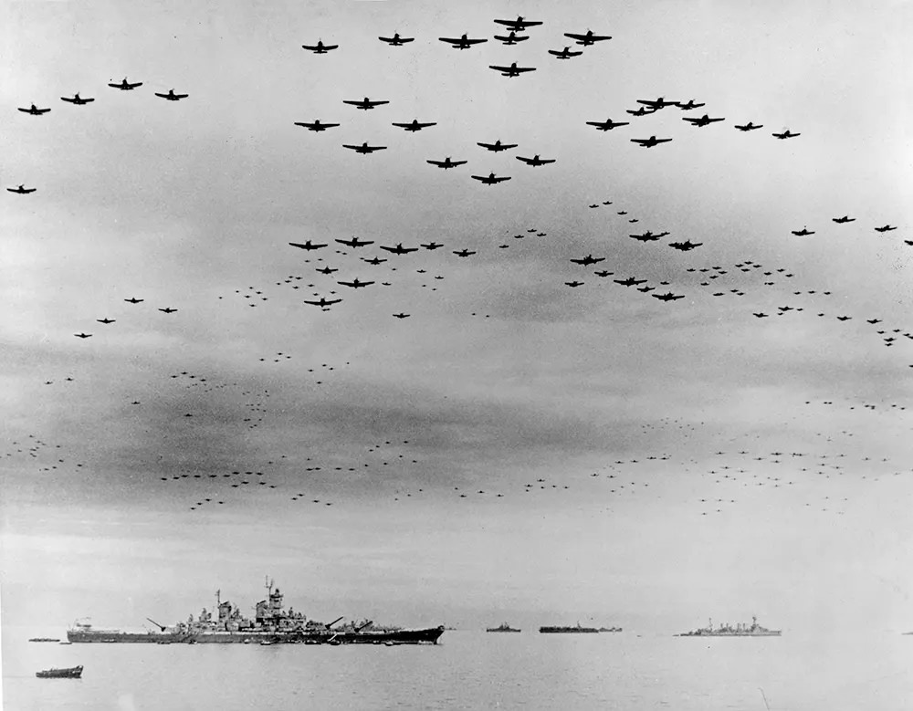#9 Navy carrier planes fly in formation over the U.S. and British fleets in Tokyo Bay during surrender ceremonies.