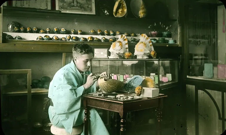 #10 Man painting shells.