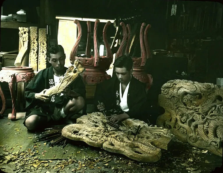 #13 Men carving wooden furniture of intricate design.