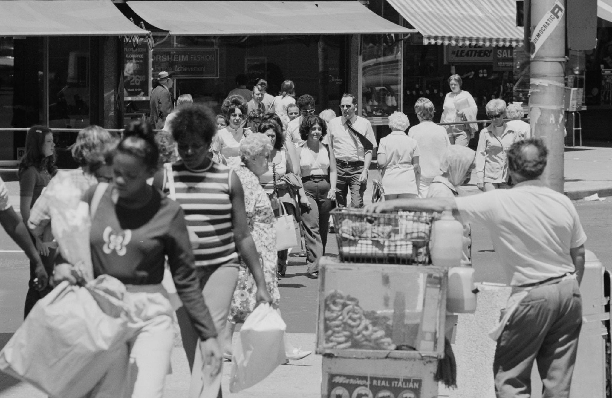 #6 View of pedestrians crossing the street at an unidentified street corner of Jersey City, New Jersey, 1974.