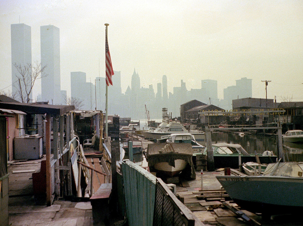#46 Greene Street Boat Club in Jersey City with the Lower Manhattan skyline and the World Trade Center in the distance, 1975