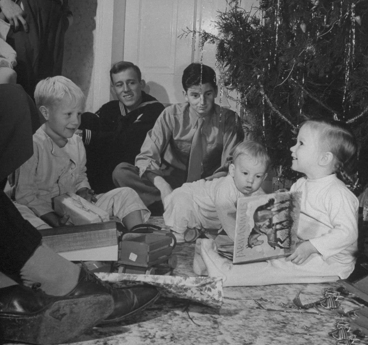 #13 Grandchildren of James F. Irwin opening presents during an early Christmas party to celebrate safe return of sons and sons-in-law from WW II.