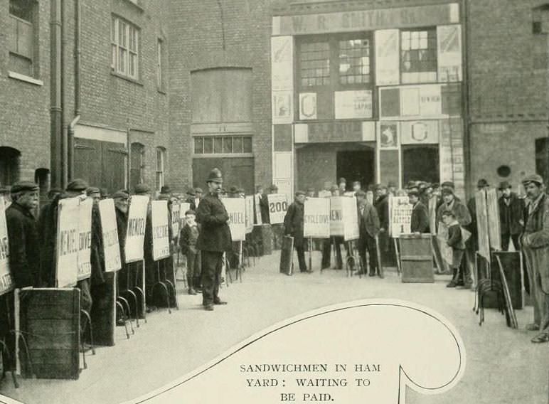 #5 Sandwich men waiting to be paid in Ham Yard in Soho.