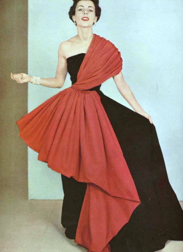 #1 Model in intricately draped red faille on black faille gown by Grès, 1950