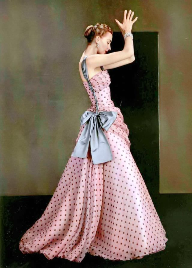 #10 Marie-Thérèse is wearing pink organza dotted evening gown adorned with large grey satin bow by Grès, 1953