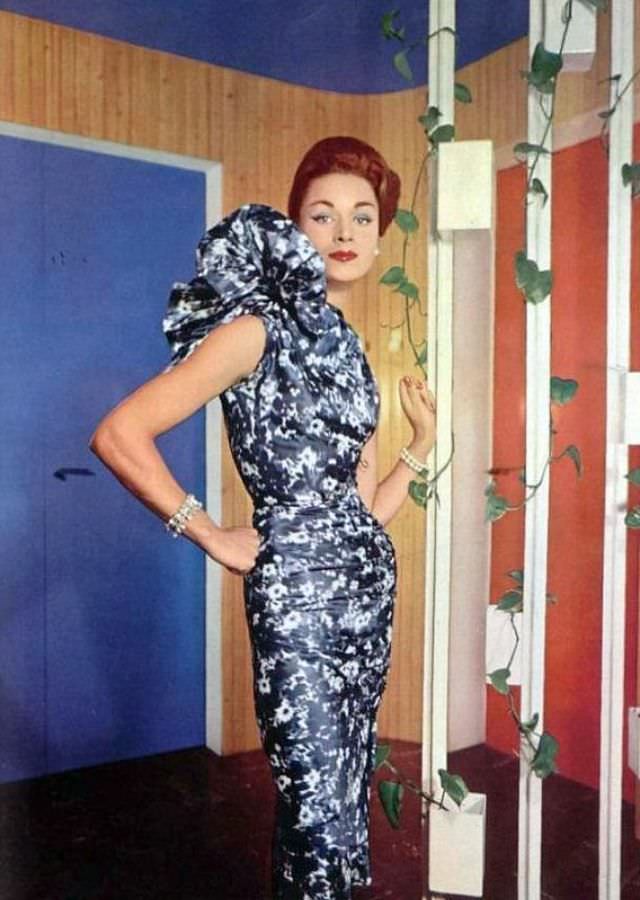 #20 Elegant blue and white silk print dress with enormous coxcomb on one shoulder by Grès, photo by Philippe Pottier, L’Officiel, 1957