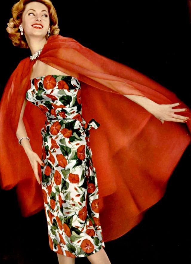 #29 Ghislaine Arsac is wearing strapless silk floral print dress with vibrant red organdy cape by Grès, L’Officiel, 1958