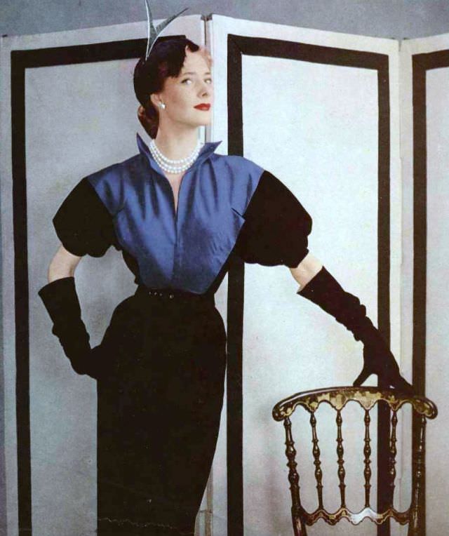 #3 Model in black wool sheath dress, the bodice is of peacock blue faille, by Grès, 1951