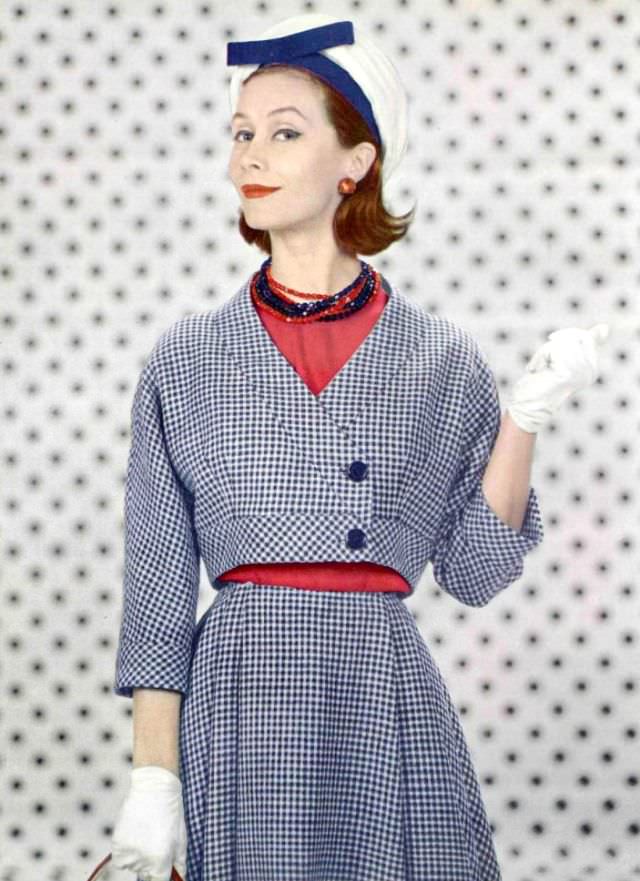 #34 Gigi Terwalgne in blue and white wool houndstooth, short collarless bolero worn over red silk blouse by Grès, hat by Jane Blanchot, 1959