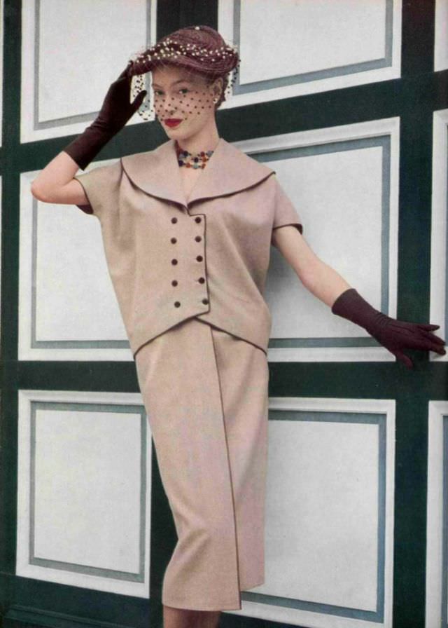 #6 Anne Campion in dusty pink flannel two-piece by Grès, hat with voilette by Rose Valois, 1952