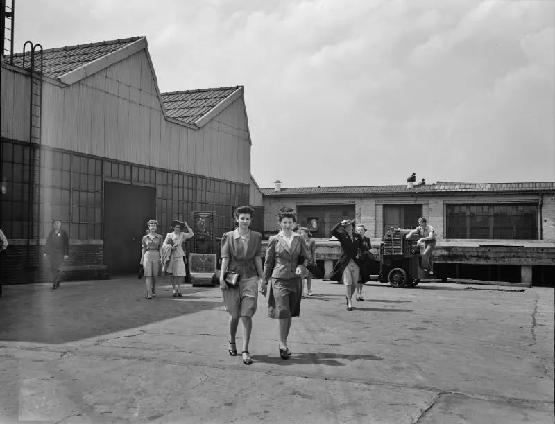 #21 Girls coming out of the Highland Park Chrysler plant in Detroit, Michigan, 1942.