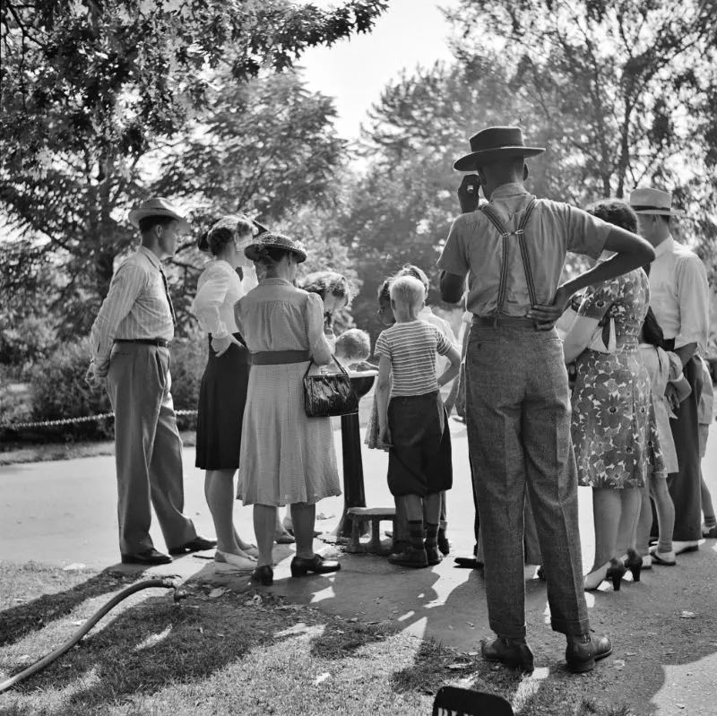 #22 Group waiting to drink water out of a public fountain in the zoological park, Detroit, Michigan, July 1942.