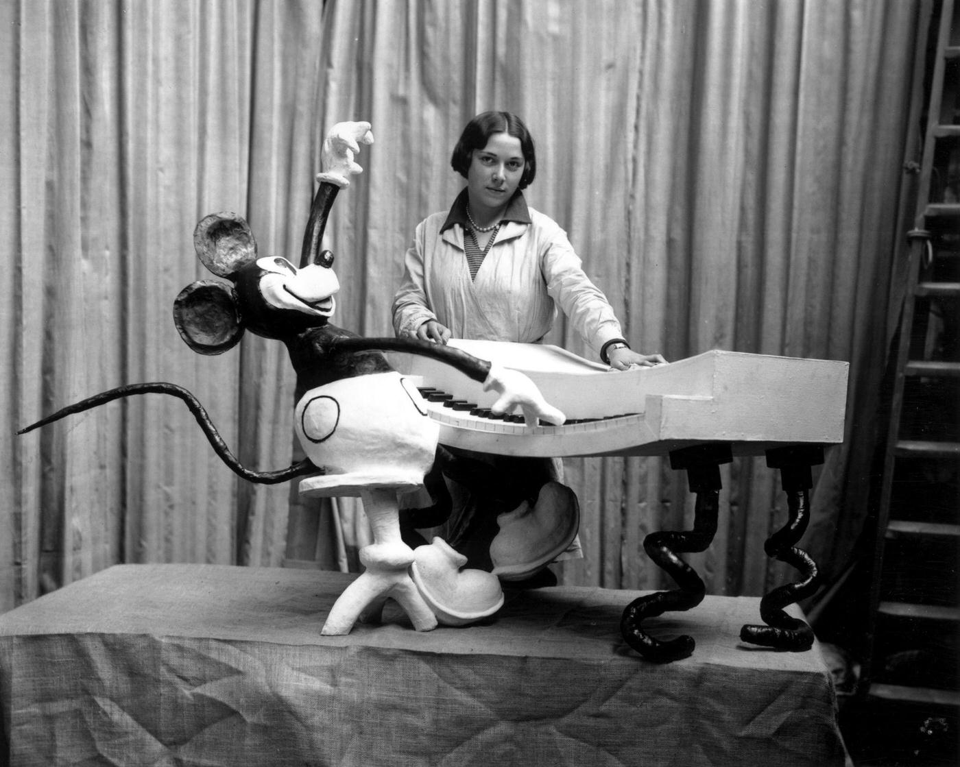 An employee at Madame Tussaud’s waxworks museum on Marylebone Road, London, putting the finishing touches to a waxwork of Mickey Mouse at the keyboard
