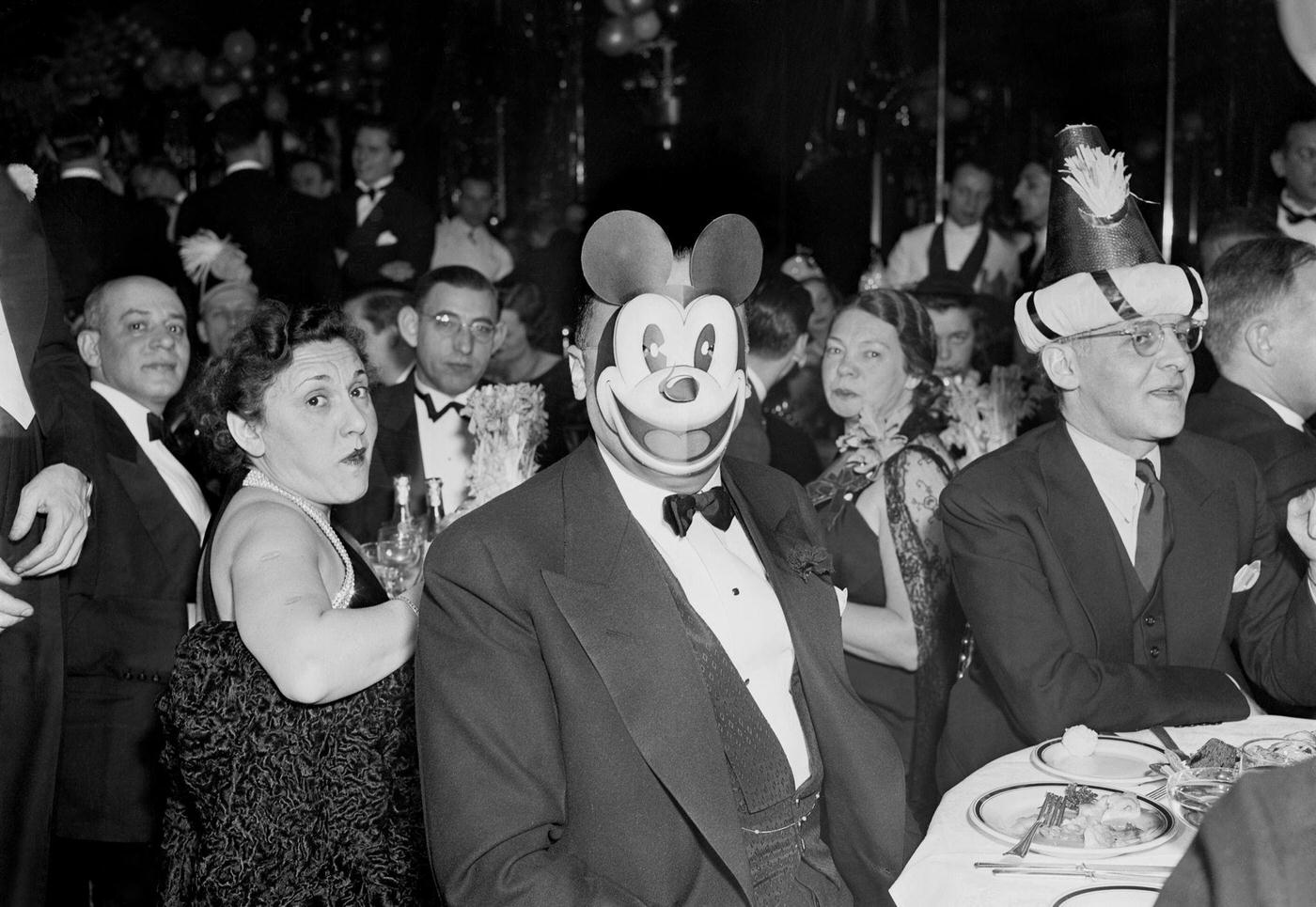 That’s J. Edgar Hoover behind the Mickey Mouse mask at a New, 1937