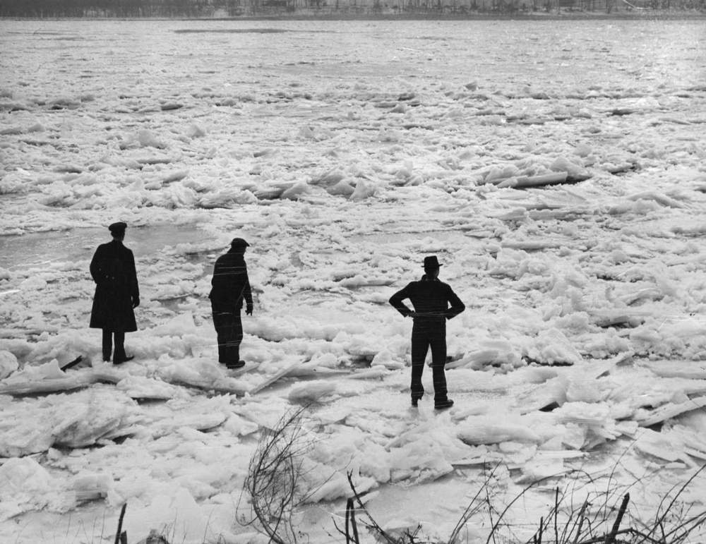 #1 Three men prepare to walk across the river from the foot of Gasconade Street in south St. Louis on Feb. 7, 1936, after a massive ice jam covered the river.