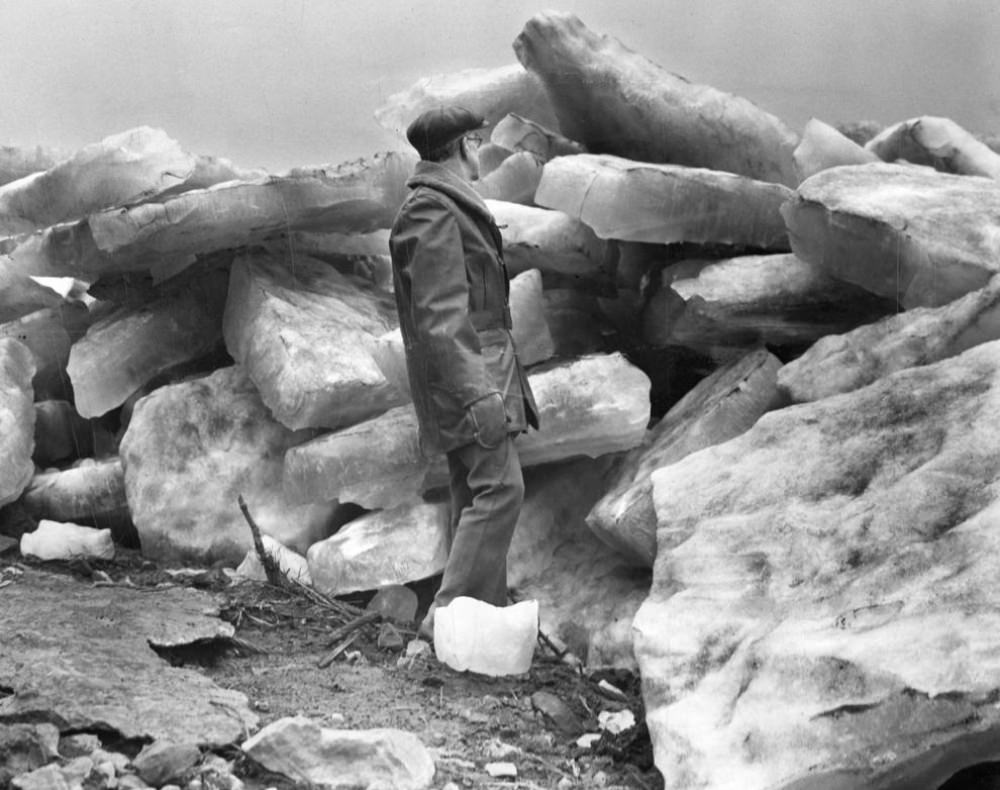 #6 A man examines some of the chunks of ice along the St. Louis riverfront on Feb. 26, 1936, after the ice jam across the Mississippi river began breaking up.