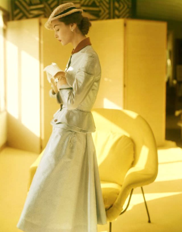 #2 Eva Gerney wearing a suit of silk taffeta with peplum and velvet collar by Mollie Parnis, photo by Horst P. Horst, February 1951