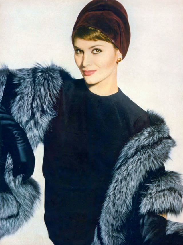 #23 Isabella Albonico in black worsted jersey dress by Mollie Parnis, a raisin-colored velours hat by Sally Victor, and stole of black-dyed Russian broadtail lamb and Canadian fox by Fredrica, September 15, 1958