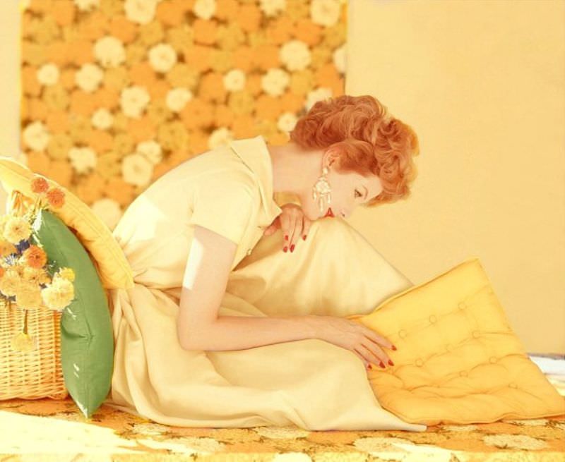 #24 Model wearing yellow dress with rhinestone buttons, by Mollie Parnis, and earrings by Mosell, 1959