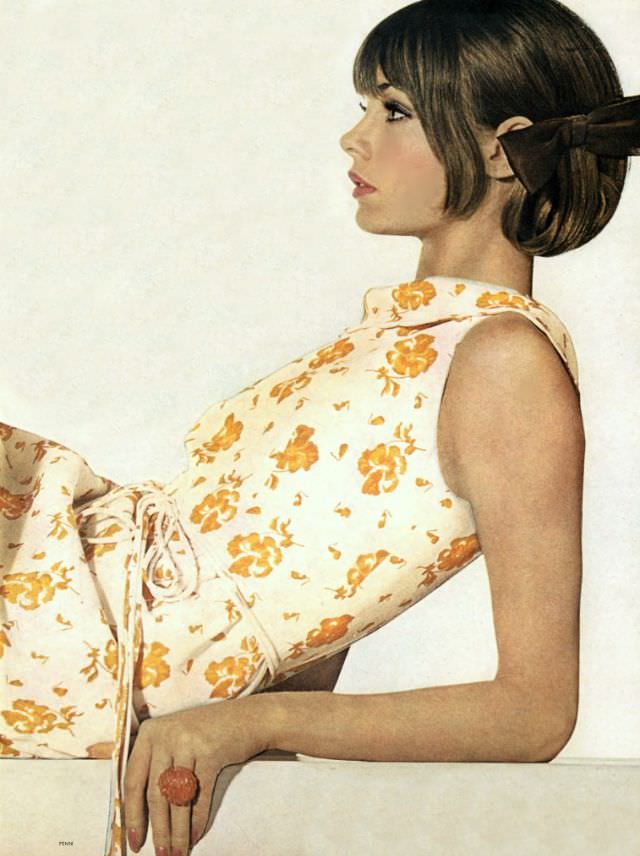 #30 Jean Shrimpton in white linen dress printed with spice-yellow pansies, with turtleneck and string tie at the waist by Mollie Parnis, KJL ring, June 1, 1964