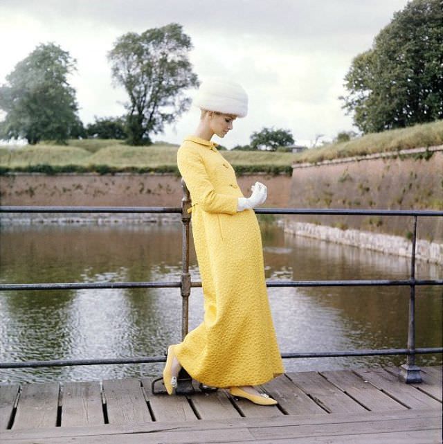 #31 Model in an evening coat of yellow matelasse by Mollie Parnis, Denmark, Vogue, October 1, 1964