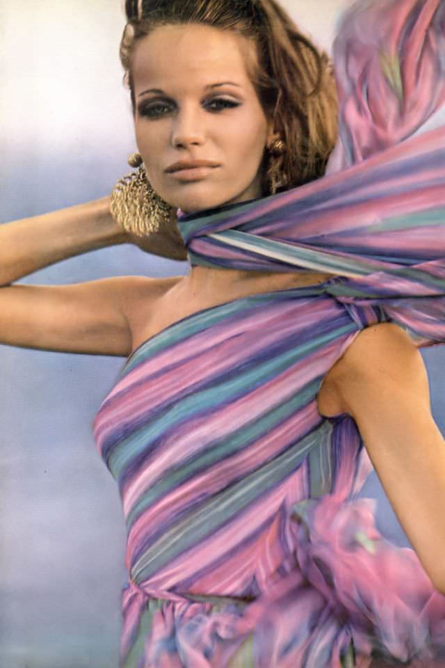 #33 Veruschka in beautiful colorful silk chiffon dress that scarfs one shoulder and swirls the body in a silken swirl, by Mollie Parnis, Vogue, April 1, 1965