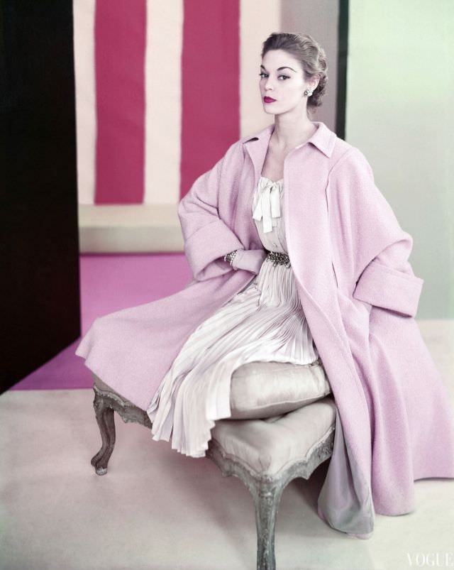 #4 Jean Patchett wearing pale pink poodle coat by Swansdown over dress of pleated silk Shantung by Mollie Parnis, jewelry by Miriam Haskell, 1952