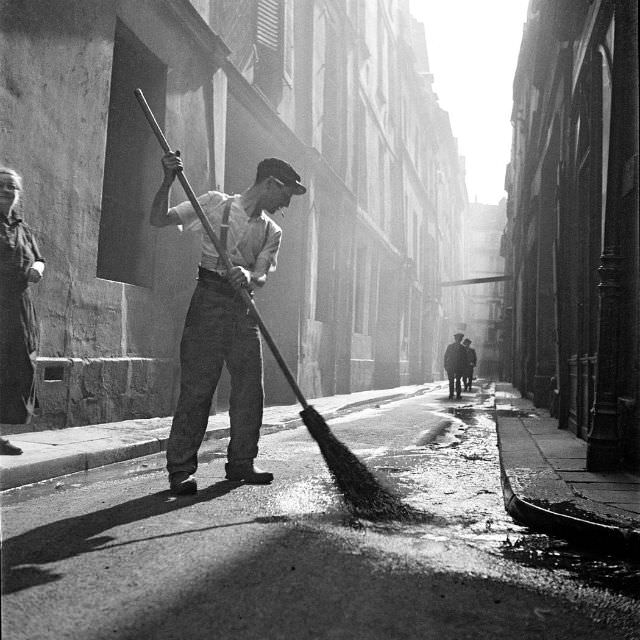#12 Street sweeper on rue Visconti, Paris, 1935.