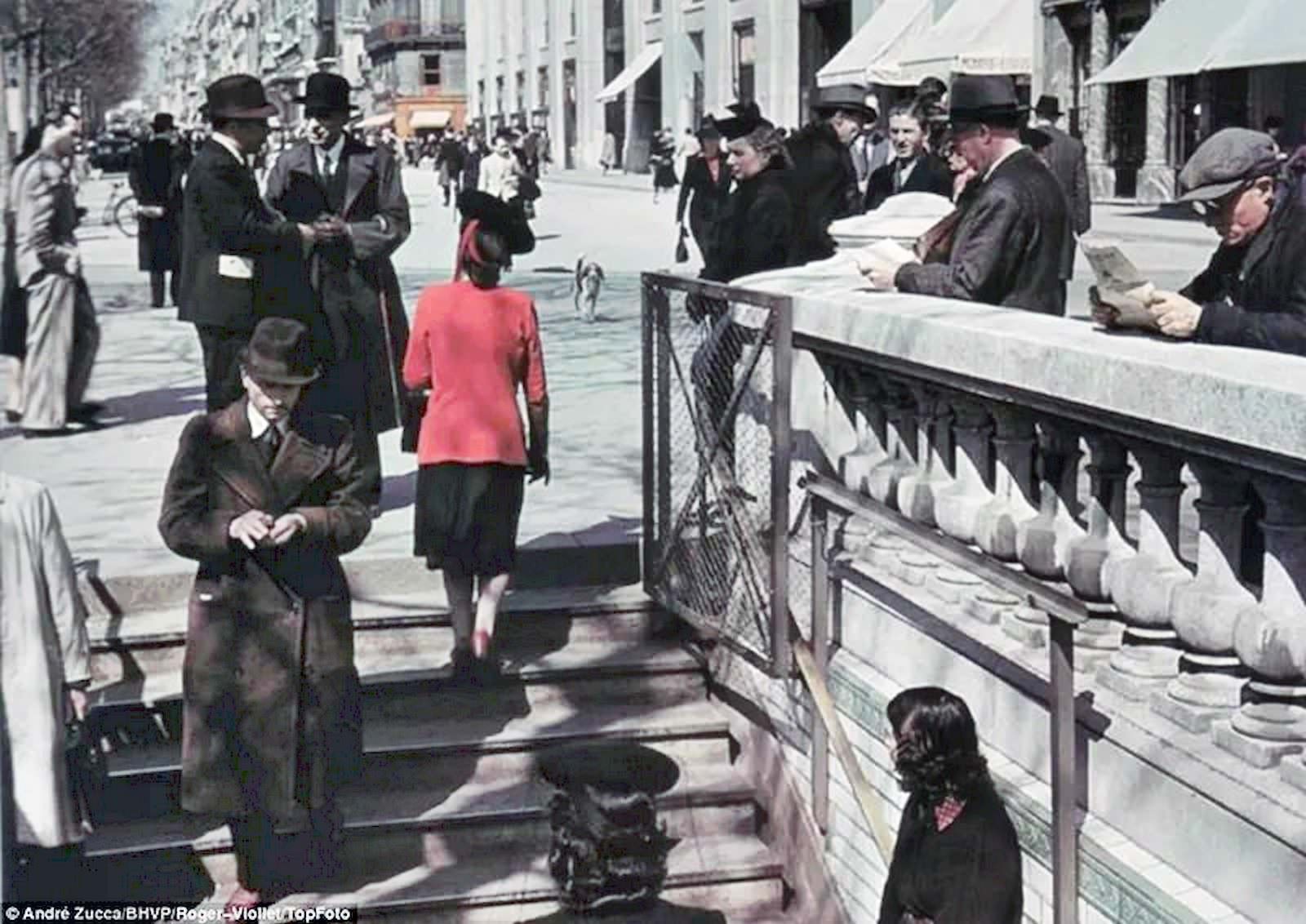 #27 Parisians go about their business, walking down into a subway.
