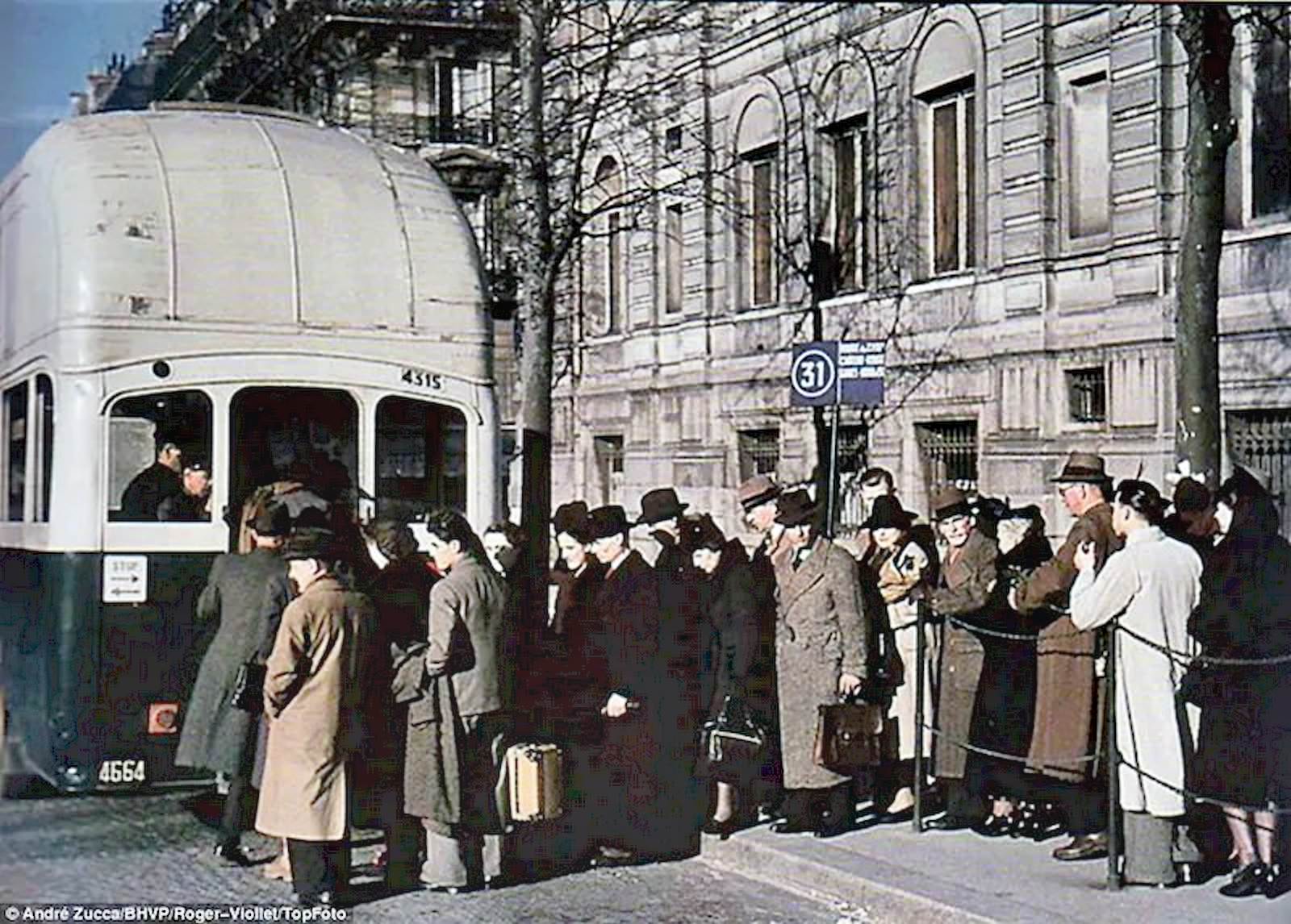 #45 Parisian commuters queue to board a bus on a chilly early morning.