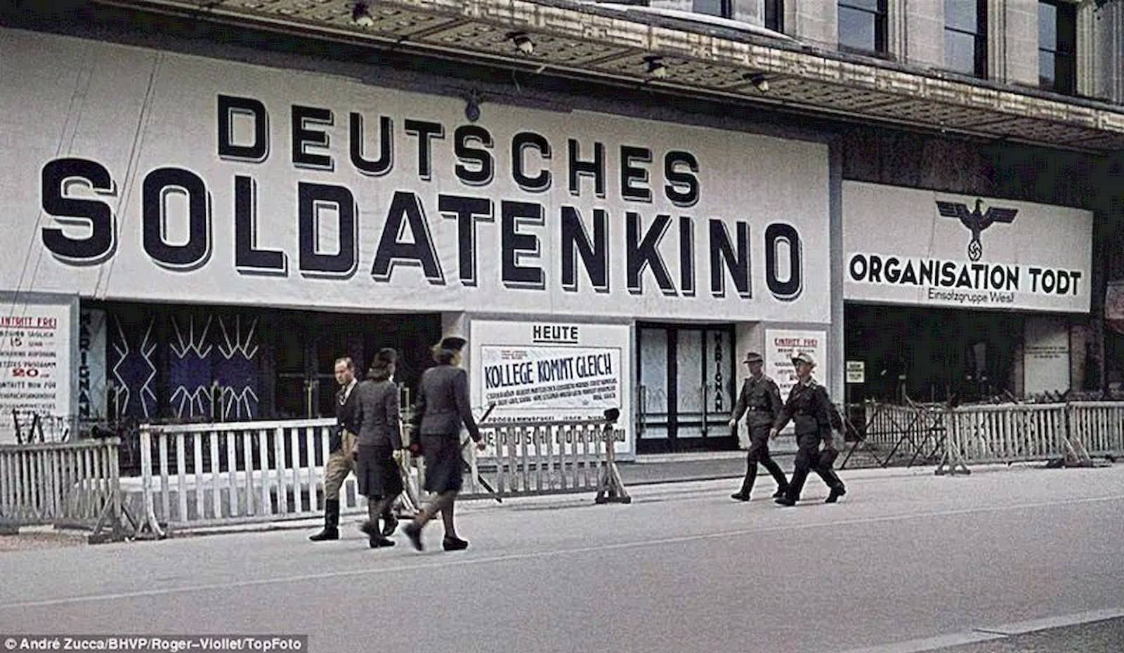 #63 A theatre, which has an Imperial Eagle painted on its wall, proclaims itself as a German soldier’s cinema (Deutsches Soldatenkino).