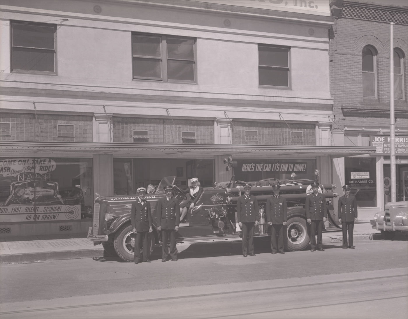 #23 Fire Truck and Firemen in Front of Miller Brothers Motors, 1930s