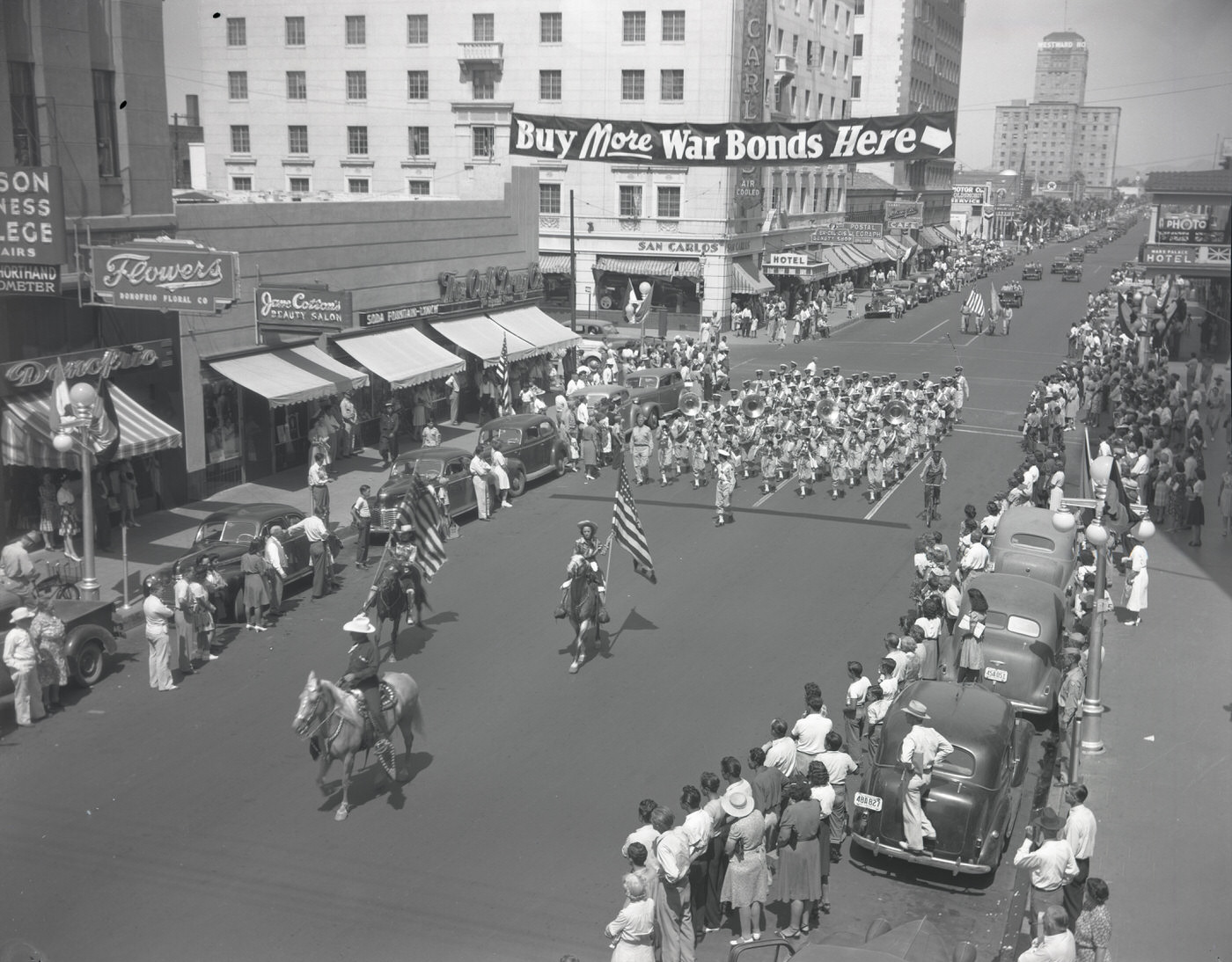 #38 War Bonds Parade. The parade is moving south on Central Ave. at the intersection of Central Ave. and W. Monroe Street, 1943