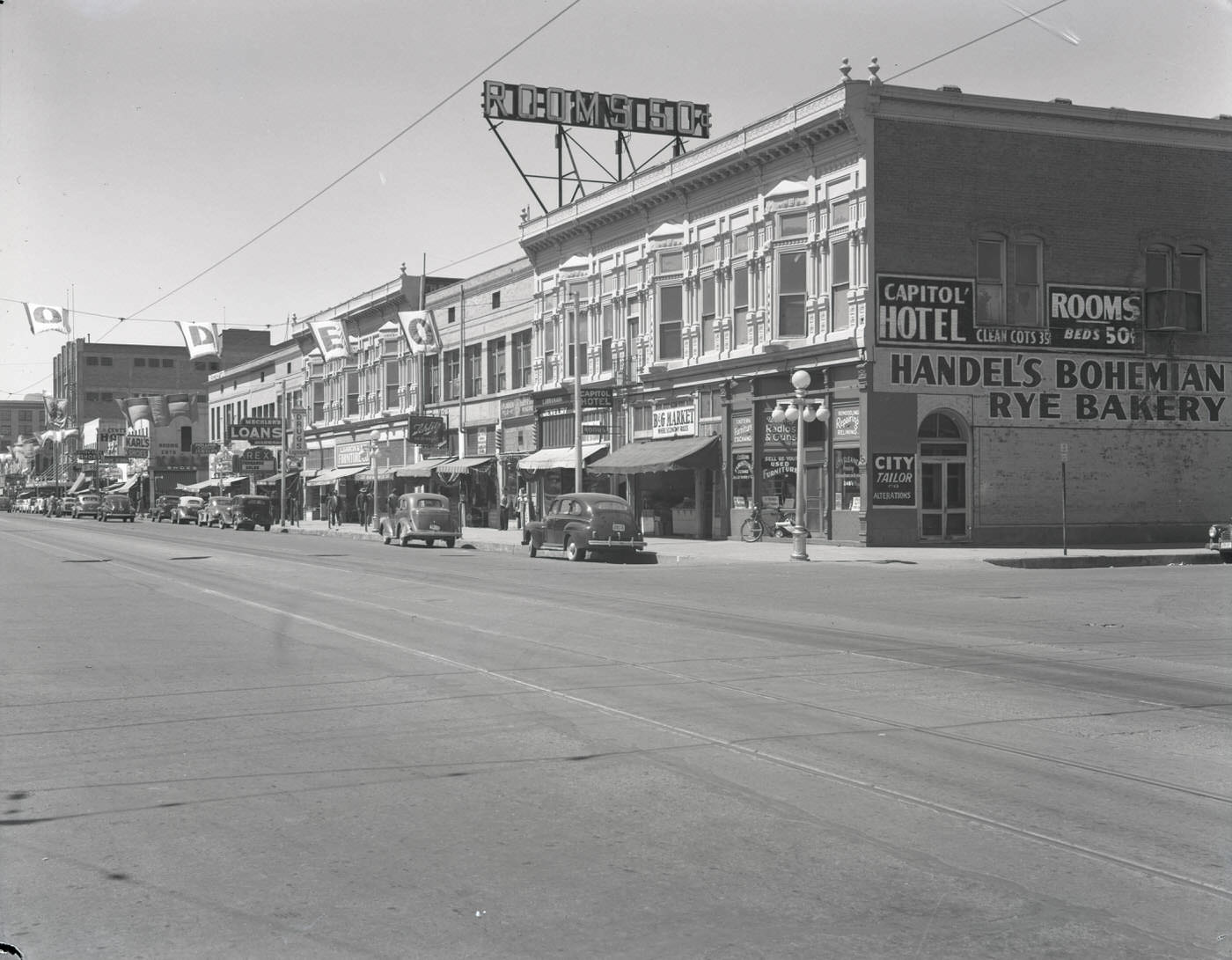 #36 200 Block of E. Washington St., 1945. View looking west down E. Washington St. at the 200 block. Visible are Handel’s Bohemian Rye Bakery (342 E. Washington) and the Capitol Hotel (242 E. Washington).