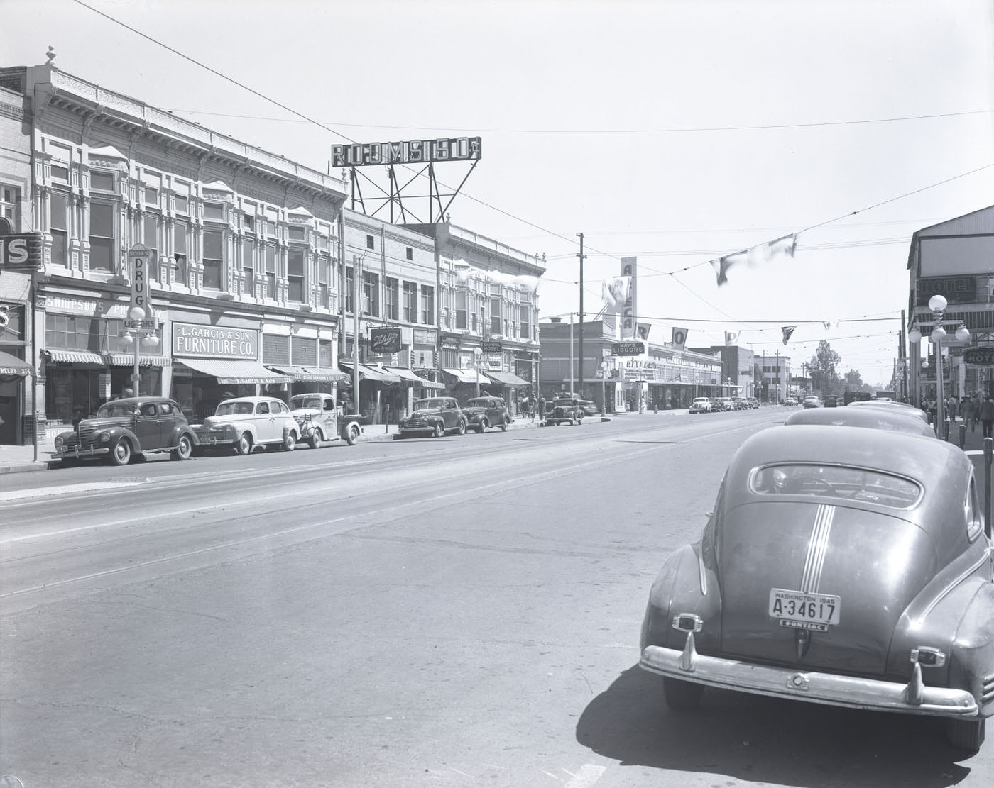 #37 200 Block of E. Washington St., 1945. View looking toward the north side of E. Washington St. at the 200 block. Visible is L. Garcia & Son Furniture Co. (220 E. Washington).