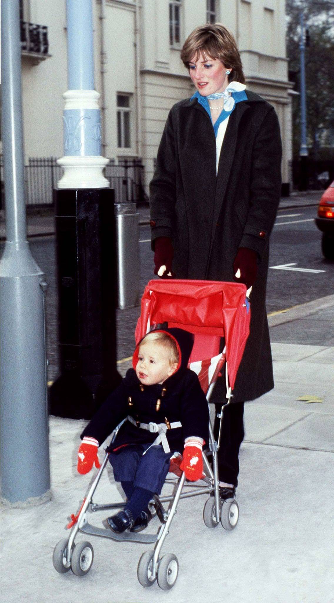 #16 Lady Diana Spencer takes her young charge Patrick Robinson for his daily outing in the Eaton Square district of London during her time as a nanny, November 1980.