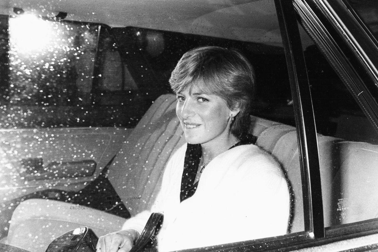 #47 Lady Diana Spencer, fiance of Prince Charles, in the back of a car leaving her flat in London, February 1981.