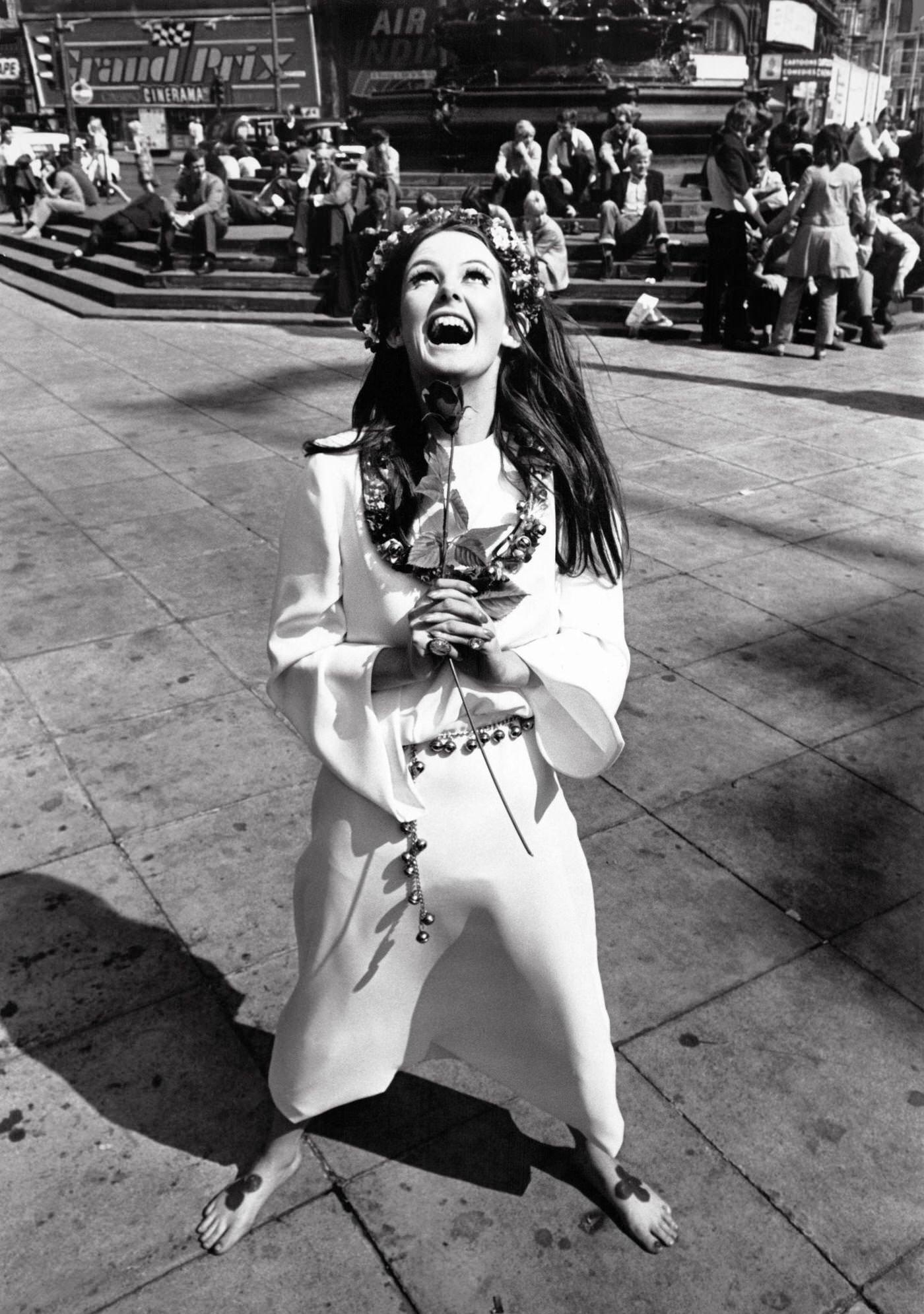 #12 Model Lesley Hill wearing a ‘Young’s Dress Hire’ hippie wedding dress with a flower crown in her hair at Piccadilly.