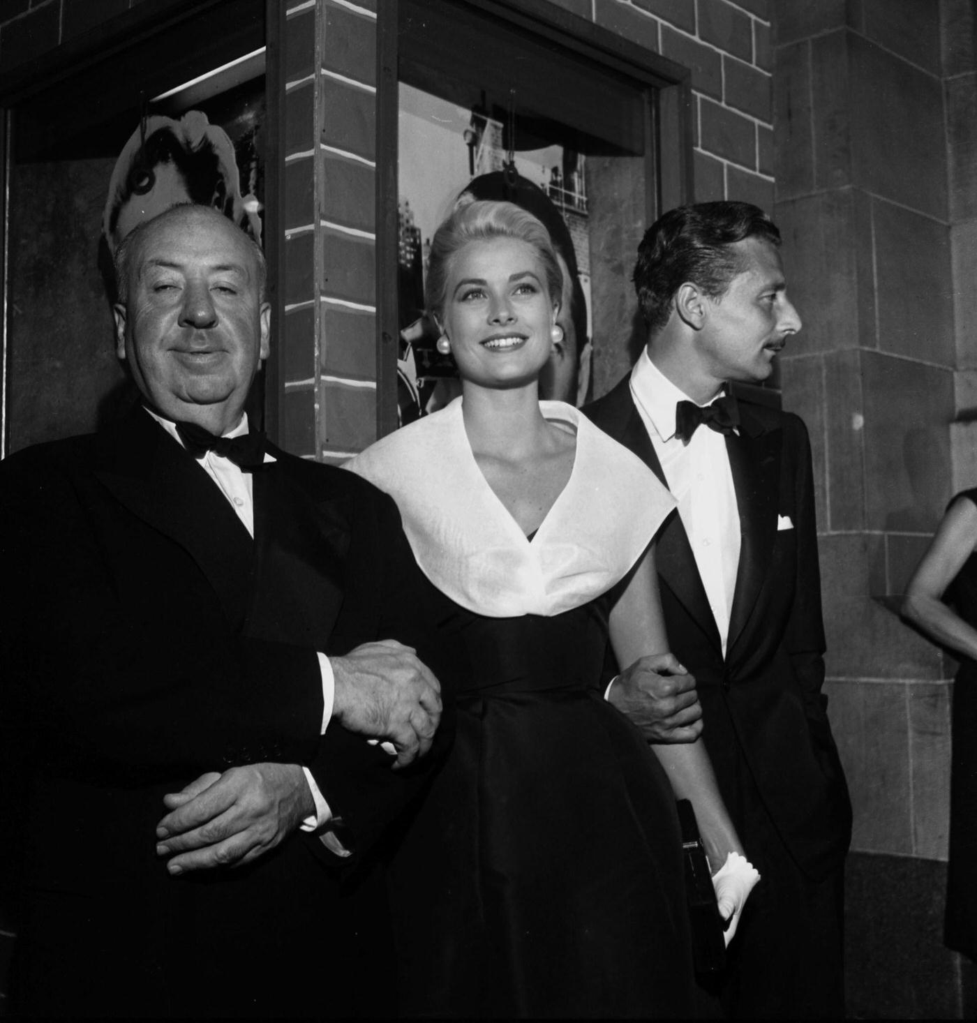 Director Alfred Hitchcock with actress Grace Kelly and Oleg Cassini at the premier of “Rear Window” in Los Angeles, California.