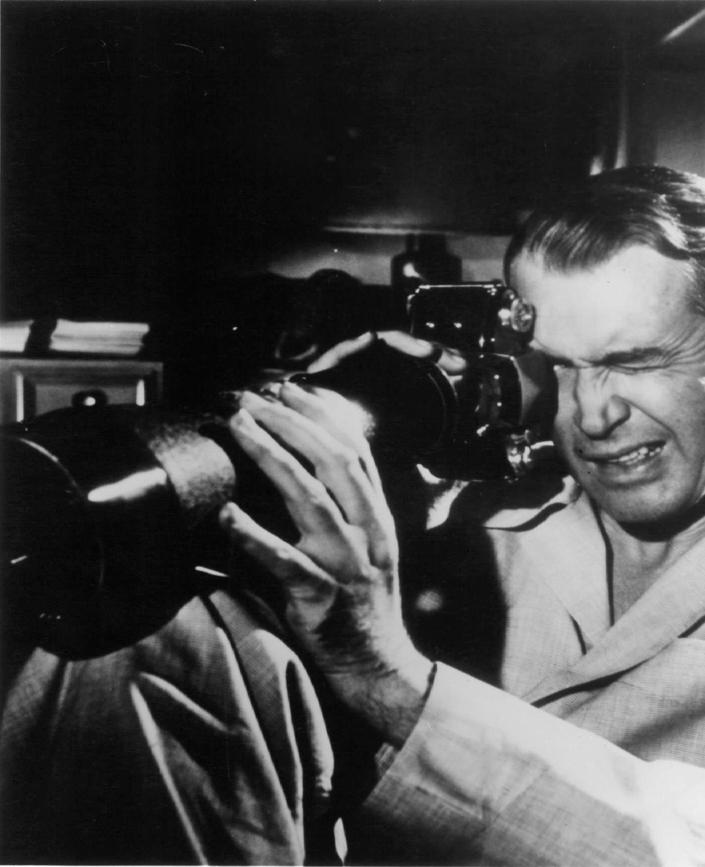 James Stewart looking through a scope in a scene from the film ‘Rear Window’, 1954.